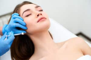 Woman relaxing while getting dermal fillers in Philadelphia, PA