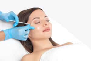 Woman with eyes closed getting dermal filler injections in Philadelphia, PA