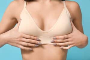 Woman's breasts in tan bra after breast explant surgery in Main Line Philadelphia, PA